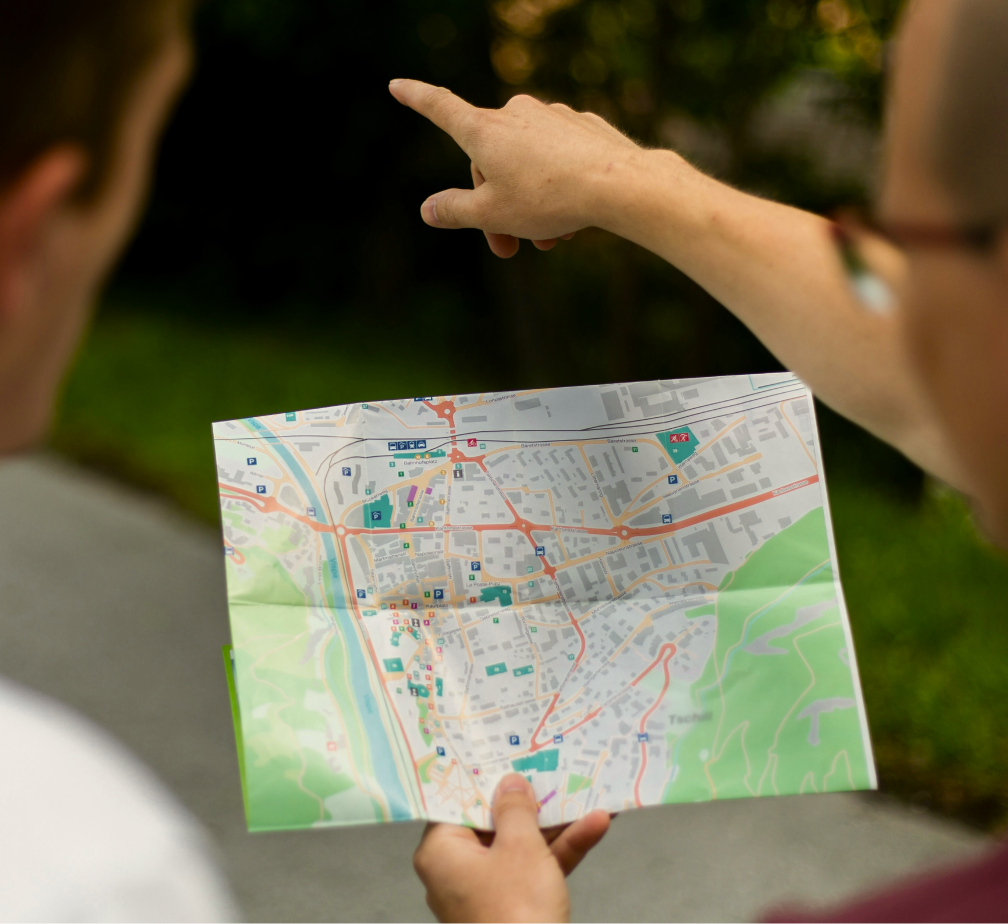 two men searching property from map