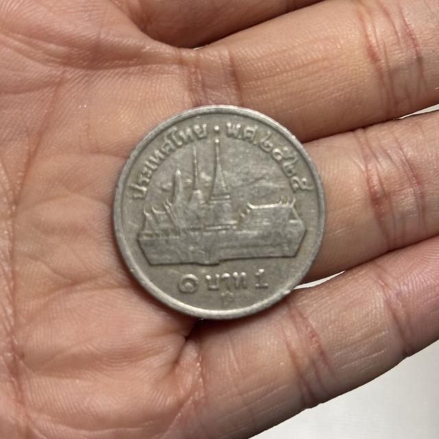 เหรียญ 1 บาท กษาปณ์หมุนเวียน รัชกาลที่ 9 ด้านหลังเป็นรูปวัดพระศรีรัตนศาสดาราม (วัดพระแก้ว) พ.ศ. 2525