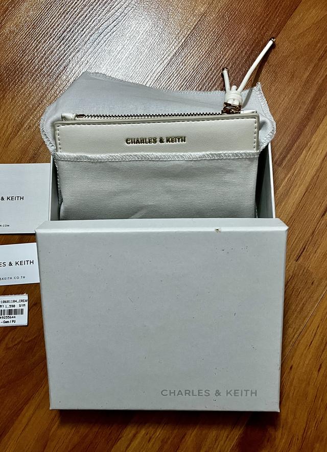 กระเป๋าสตางค์ CHARLES & KEITH ใบสั้นพับสองทบ โดดเด่นด้วยดีเทล สายดึงซิปผูกปม (Knot Charm) พร้อมช่องใส่บัตร และช่องซิปใส่เหรียญ ราคาช็อปไทย: 1,590 บาท รูปย่อยที่ 4
