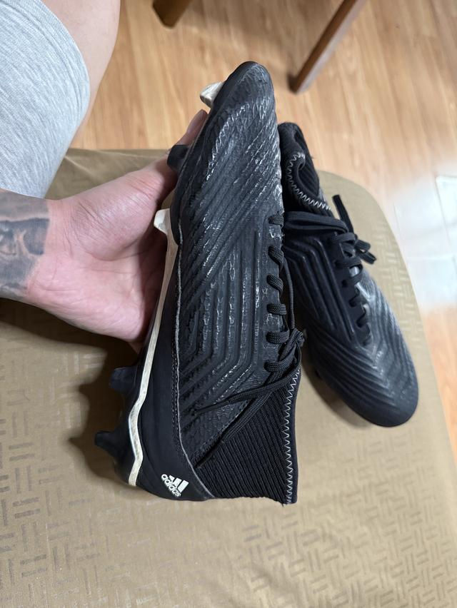 Adidas Predator 18.3 Firm Ground football boots in a black colorway.